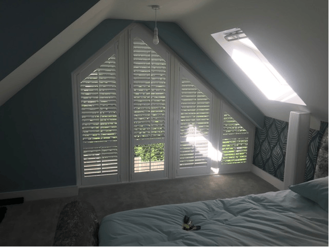 Shutters fitted around a sloping loft window