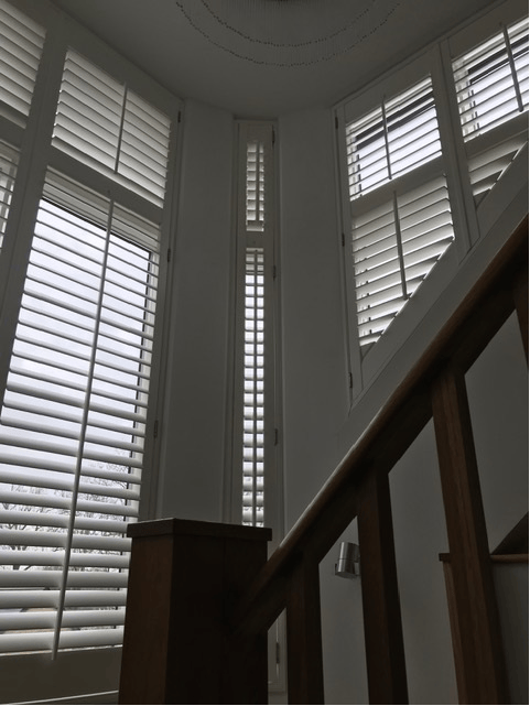 Shutters beside a staircase