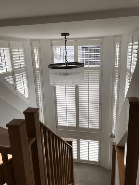 Tall stairwell window shutters