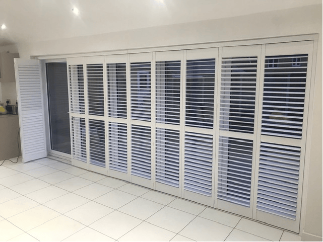 Tracked shutters across patio doors