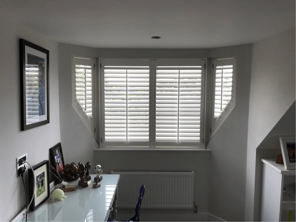 White shutters on a shaped bay